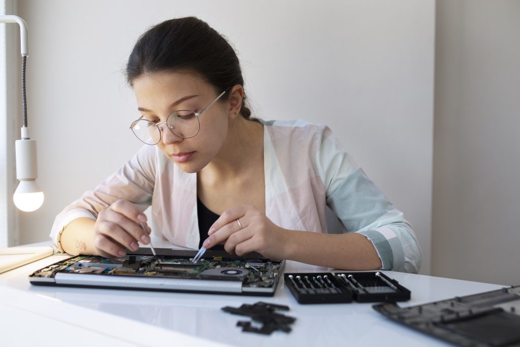 young-woman-cleaning-her-laptop-key-board 1